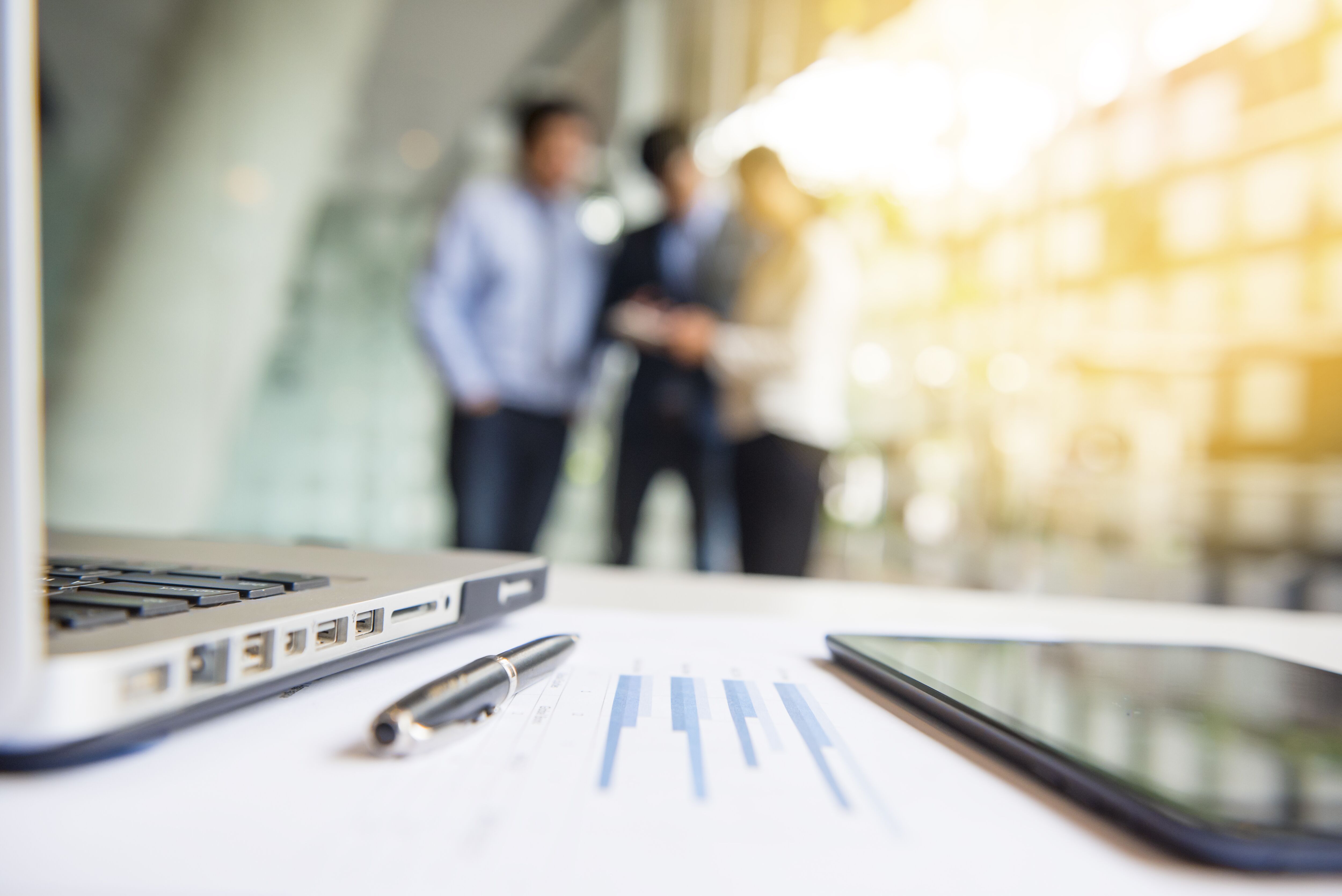 Close-shot of a pen tablet and computer displaying financial data