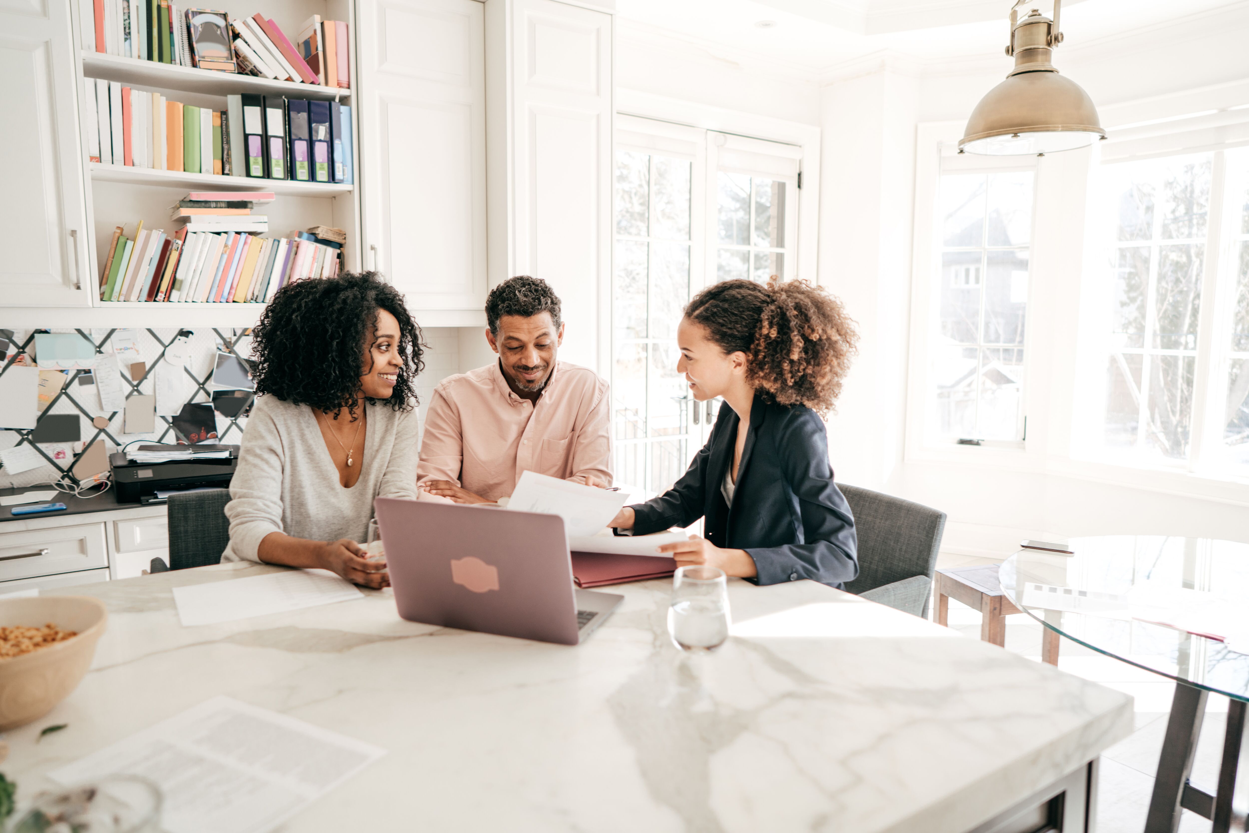 Couple working with a tax advisor in their home.