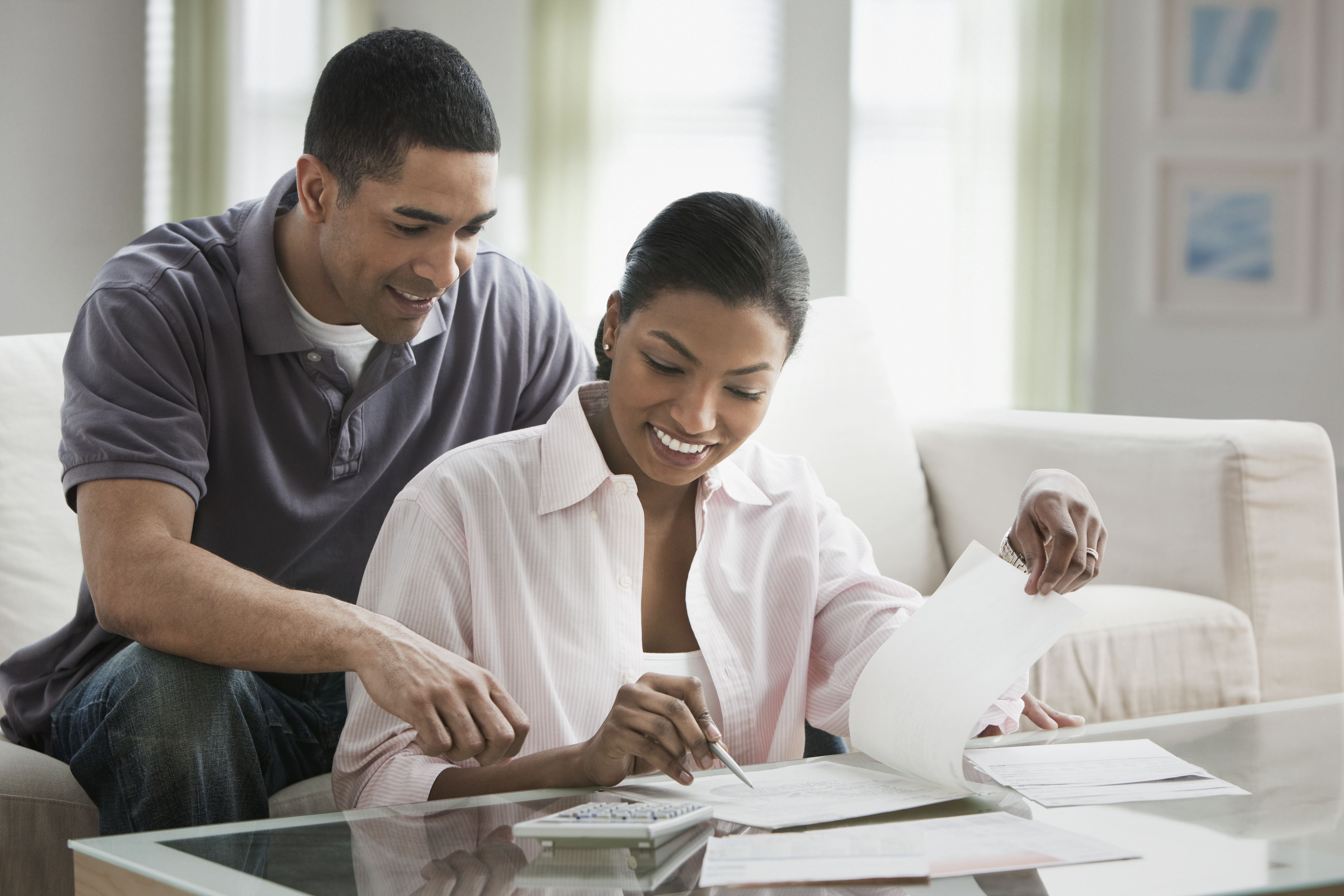 Couple paying bills in living room