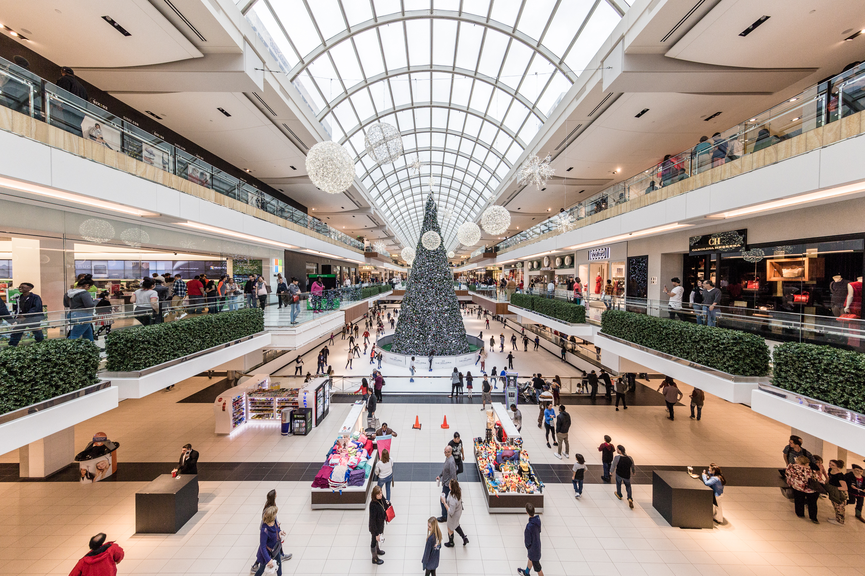 People holiday shopping in a large mall.